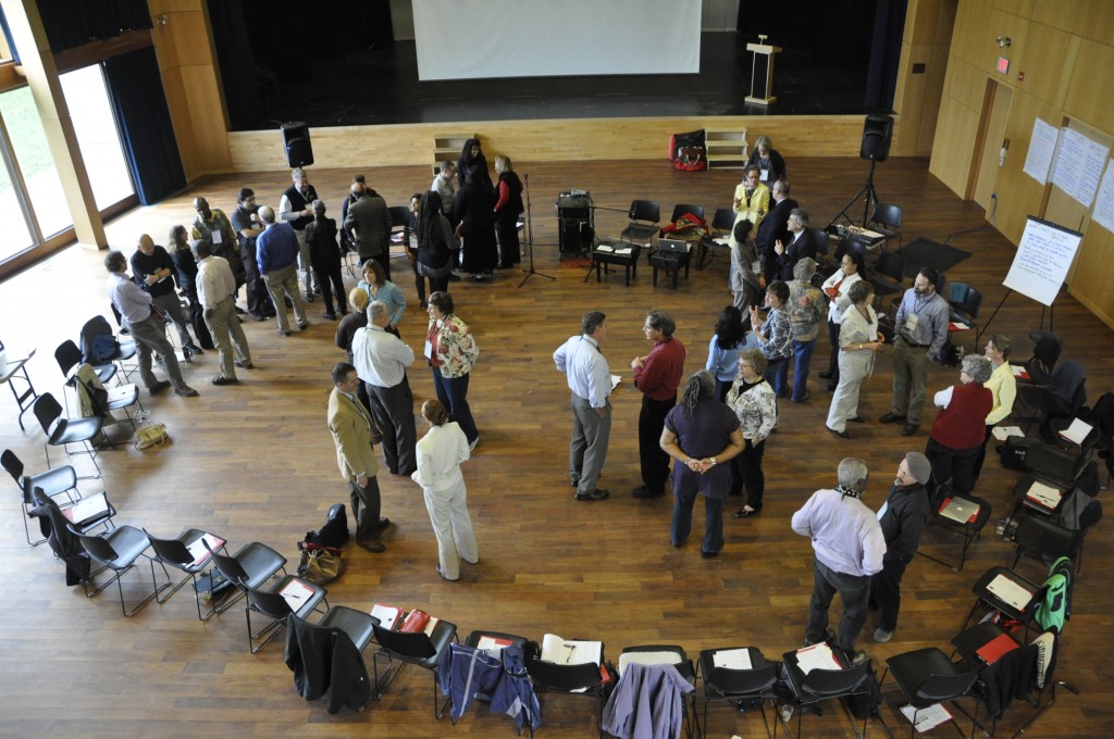 A photograph of a conference session using a process from Adrian Segar's book "The Power of Participation". Every single participant is in active conversation with someone!