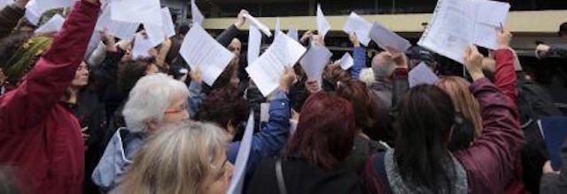 Process for selecting sessions: photograph of a crowd of people waving papers in the air