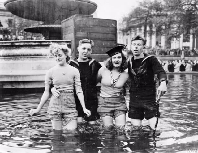 The party after the war. Photograph "Two British sailors and their girlfriends wading in the fountains in Trafalgar Square on VE Day" from the collection of the Imperial War Museums.