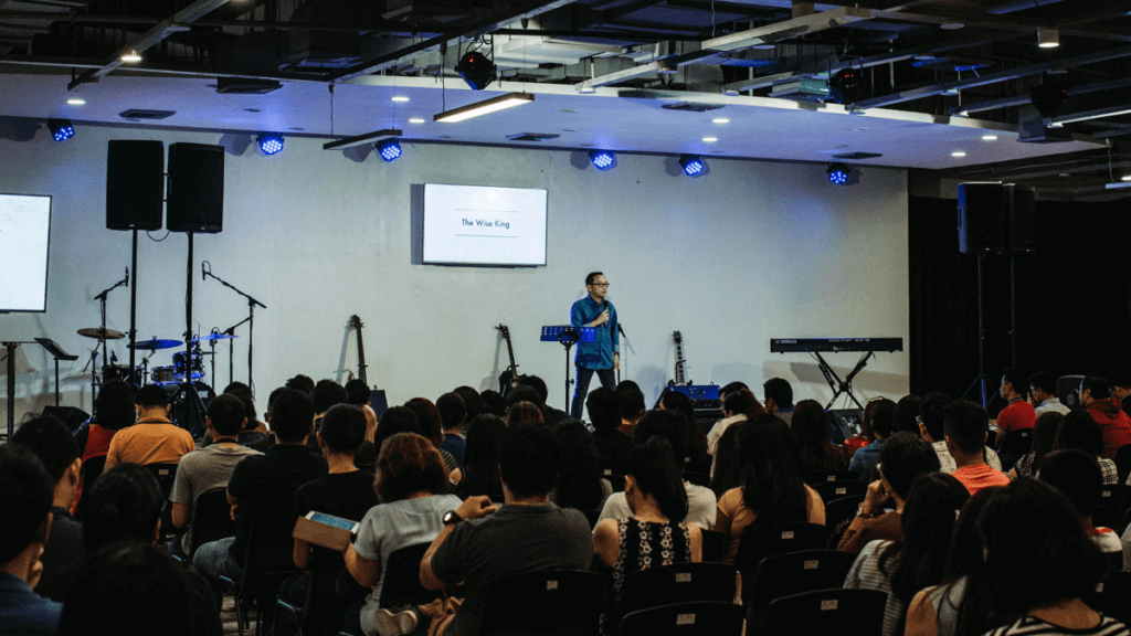 fear connecting: photograph of a speaker on a stage lecturing to an disengaged audience