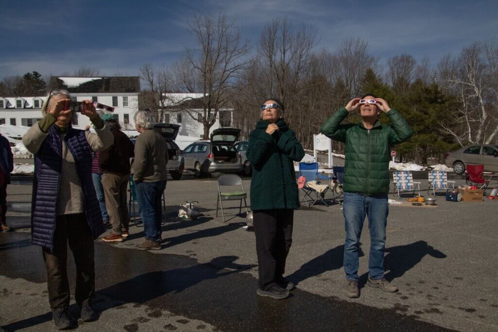 experience of awe: a photograph of Adrian Segar (on the right) and others enjoying the near-total solar eclipse in Marlboro, VT, on April 8, 2024