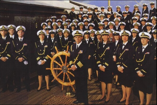 belonging: photograph of scientology's "SeaOrg" members dressed in naval uniforms standing on a wooden floor next to a ship's wheel Attribution: licensed under https://creativecommons.org/licenses/by/2.0/ from Flickr user anonymous9000